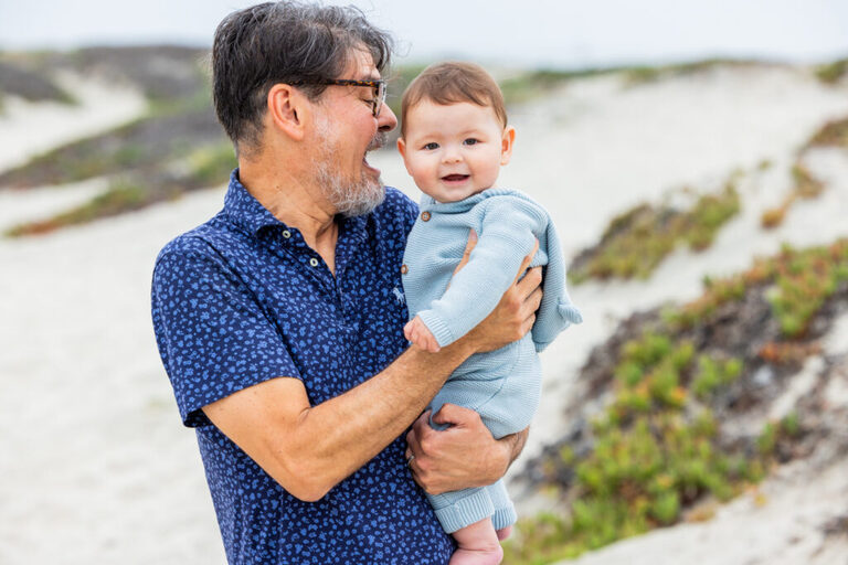 San Diego family photographer captures a family of three with their baby and dog on Coronado Beach