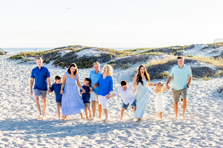 Large family celebrating together with relaxed portraits on a Coronado beach vacation