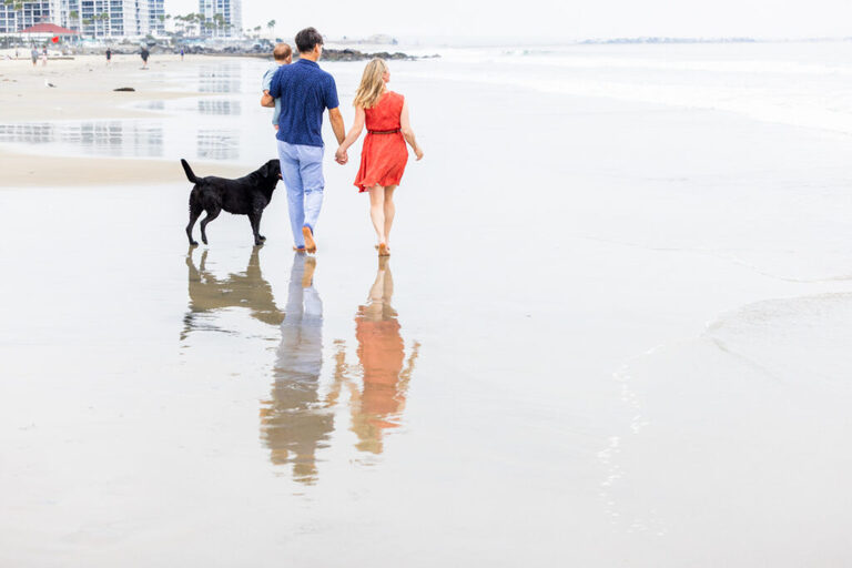 Family of three and their dog photographed together on the sand in Coronado