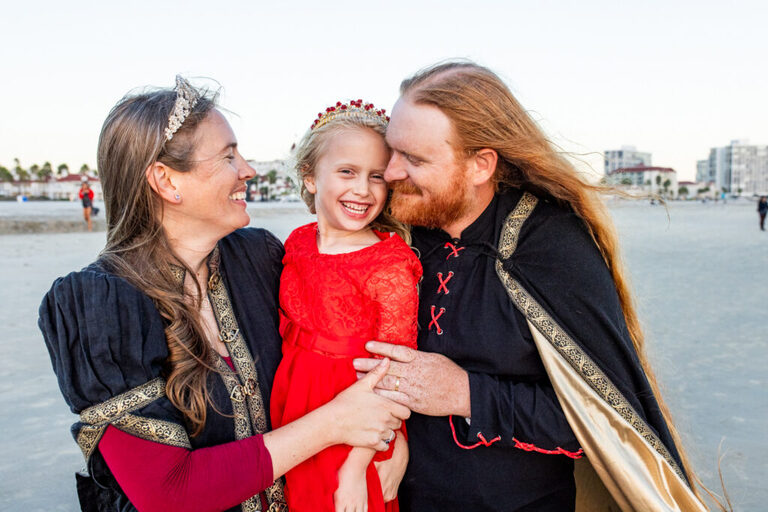 Artistic family photos on Coronado Beach featuring medieval-style clothing