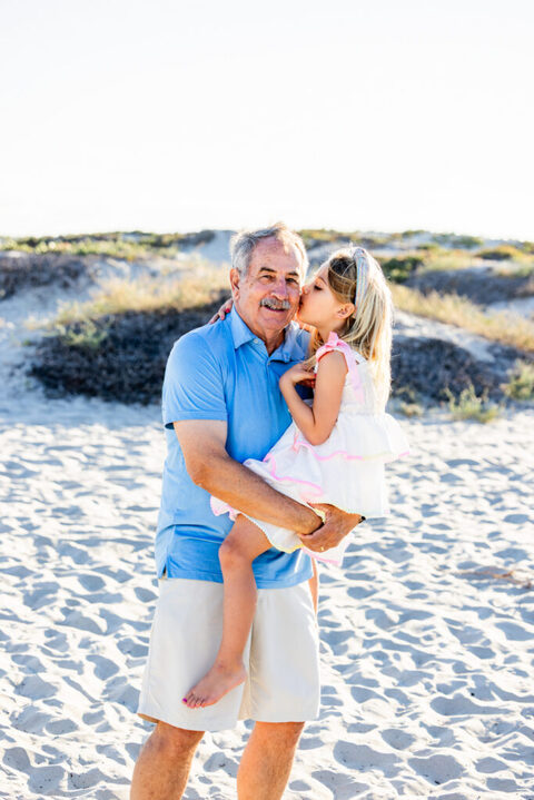Natural family portrait capturing a meaningful moment during a Coronado beach session