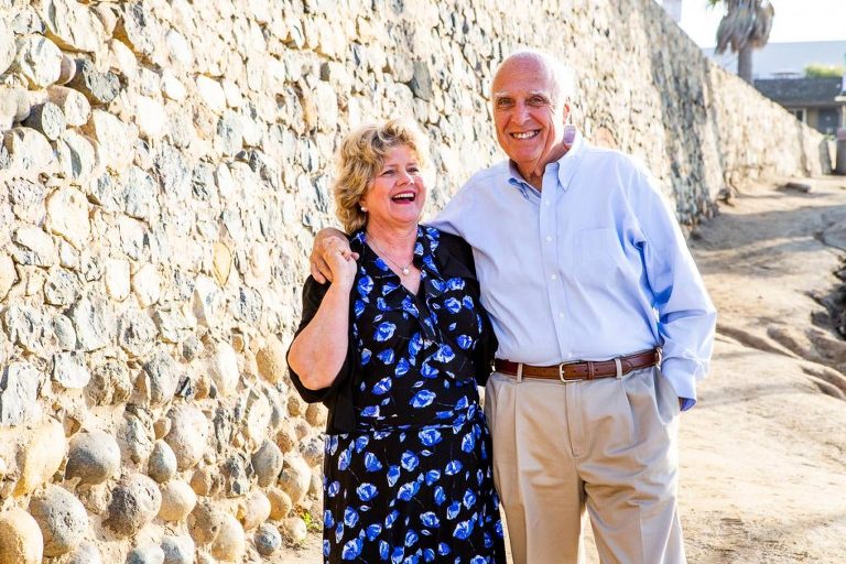 grandparents laughing by the beach