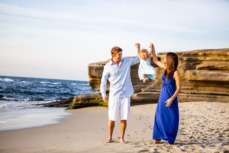 mother and father swinging daughter