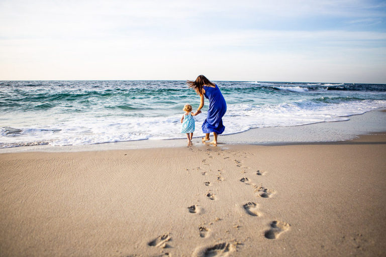 mother and daughter in the crashing waves