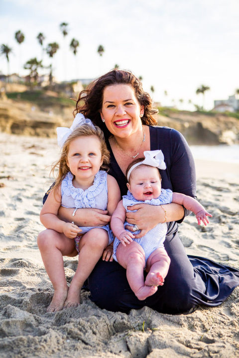 mother smiling with 2 daughters