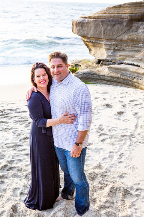 husband and wife smiling on beach
