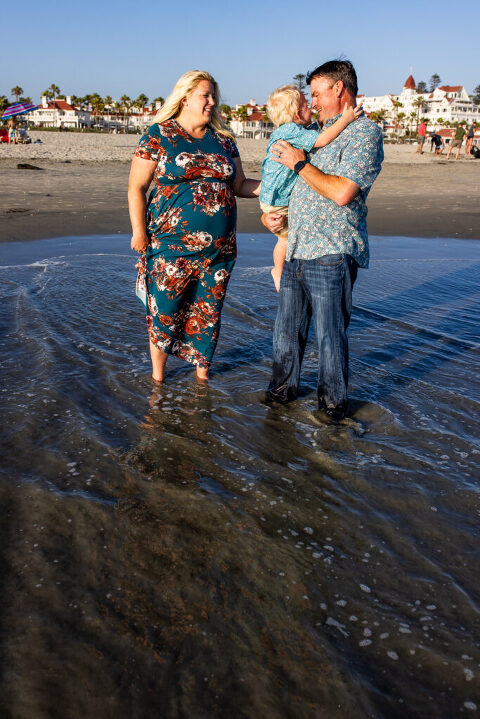 a man holding a baby in the water